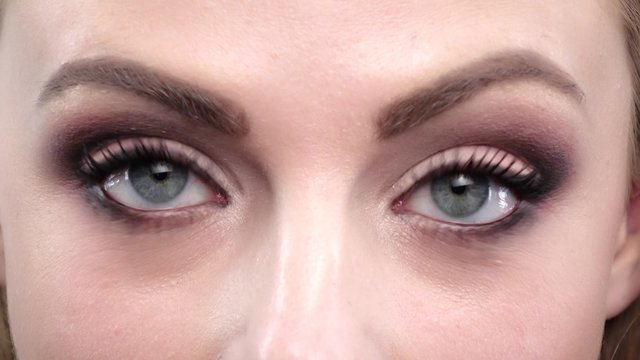 Girls blue eyes in wonder. Close up