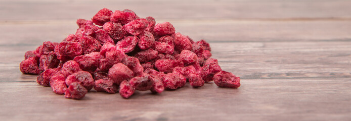 Dried pomegranate seeds over wooden background