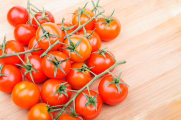 A lot of cherry tomatoes on cutting board
