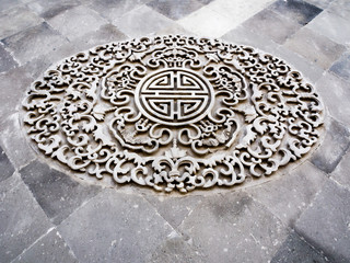 Classical Chinese ornamental design on grey brick wall