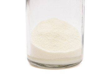 powdered milk in a bottle on white with clipping path
