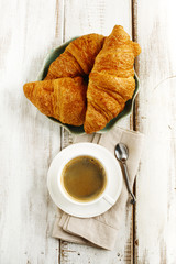 Fresh croissants and cup of coffee