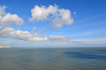 Vivid blue skies, white fluffy clouds and great sea vistas greet travellers to the South Coast of the Isle of Wight in England, UK. 