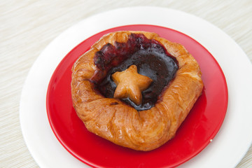 bun with jam on a saucer