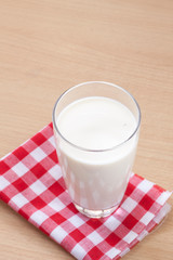 Glass of Milk on Wood with Tablecloth