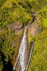 Fototapeta na wymiar Aerial view of waterfall in mountains of Kauai
