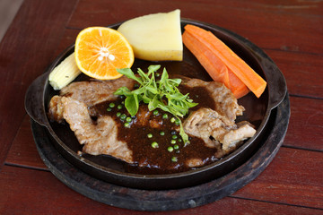 Grilled steaks, baked potatoes and vegetables.