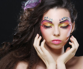 Beautiful lady with artistic make-up.