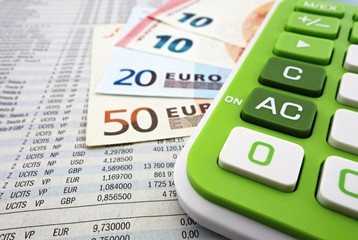 Euro banknotes and calculator on the stock numbers