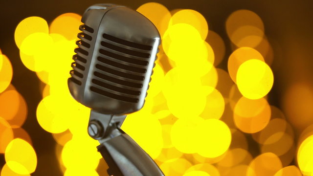 Retro microphone against colourful background