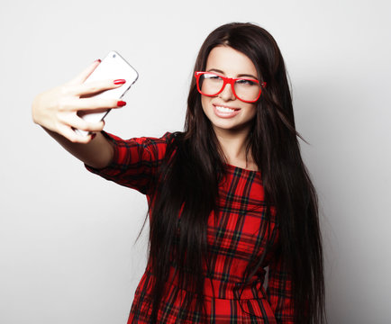 Pretty hipster girl taking selfie. 