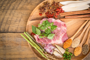 Meat with Herbs, Spices and Veggies on  Wooden Rustic Table, top