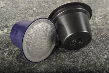 Coffee capsules on stone background
