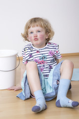 Young blond girl while sitting