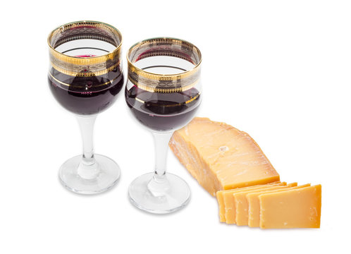 Two wine glasses with red wine and hard cheese