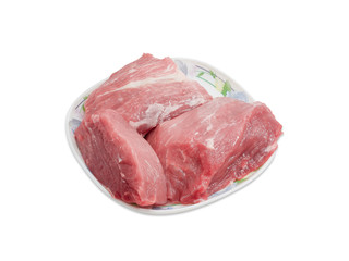 Uncooked pork on dish on a light background