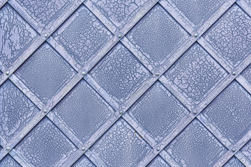 cracked paint on the blue metal fence