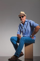 casual mature man seated hand on waist