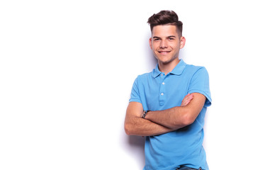 young man in blue polo shirt posing in white studio