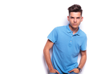 Fototapeta premium boy in polo shirt posing hands in pockets while leaning
