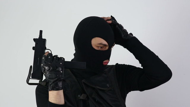 Terrorist with gun on white background