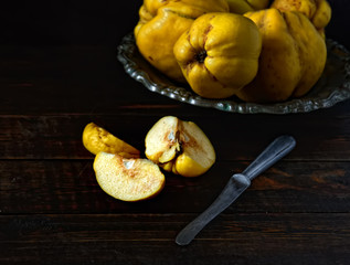 cut fruit quince on a wooden background, knife
