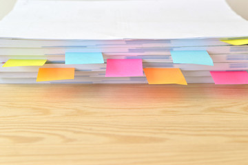 Colorful document with sticky note on wooden table