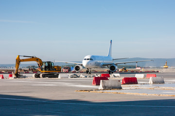 Aircraft maneuvering between excavators and bulldozers