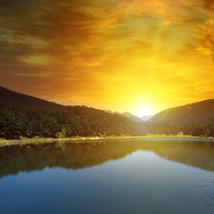 Naklejka na ściany i meble sunrise over lake and mountains