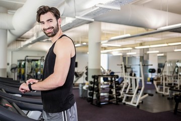 Fototapeta na wymiar Smiling man on treadmill