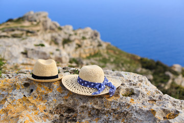 two hats on vacation in mountains