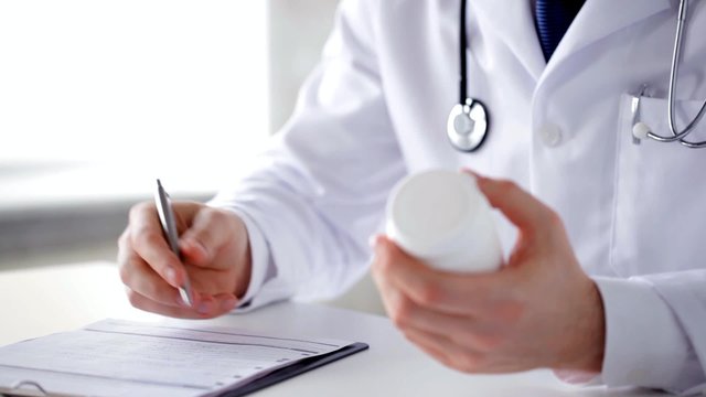 male doctor making a prescription