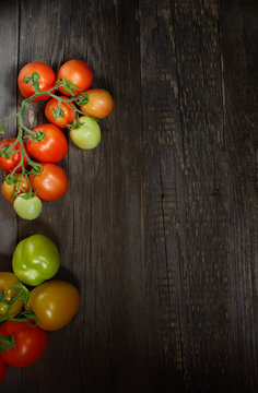 bunch of tomatoes on a wooden background