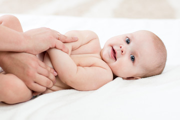 Baby massage. Mother doing gymnastics to kid.