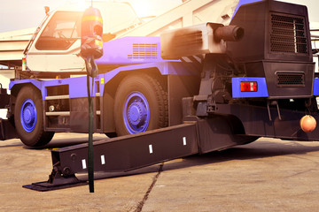 crane truck outrigger stabilizing legs extended. pump truck outrigger Heavy duty steel crane outrigger pad in construction site 