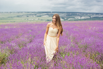 Fototapeta na wymiar Girl is walking at lavender field