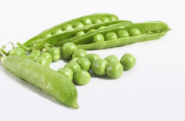 Green Peas and pea fruit the legume on white.