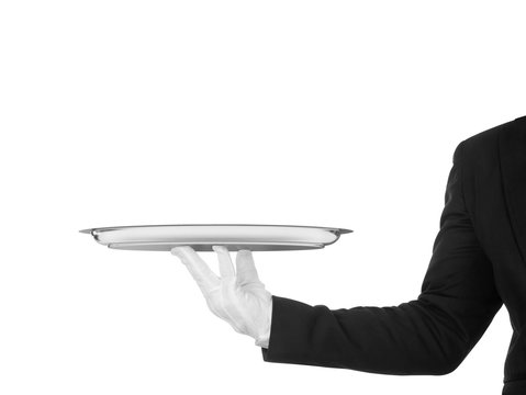 hand of the waiter in white glove with silver dish on white back