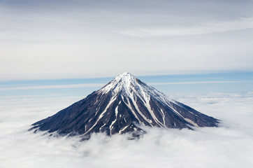 Volcanic mountains above the clouds - 106200353