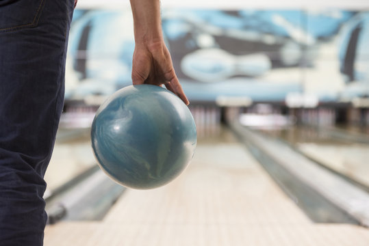 Man about to push the bowling ball