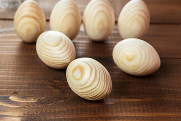 Beautiful wooden Easter eggs on a background of old brown boards with free space for your text