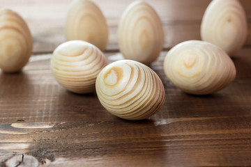 Beautiful wooden Easter eggs on a background of old brown boards with free space for your text