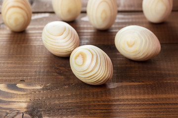 Beautiful wooden Easter eggs on a background of old brown boards with free space for your text