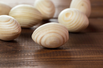 Beautiful wooden Easter eggs on a background of old brown boards with free space for your text