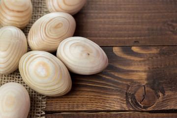 Beautiful wooden Easter eggs on a background of old brown boards with free space for your text