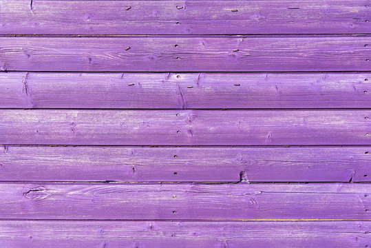 Section of purple wood panelling from a seaside beach hut. Could be used as a background to illustrate beach and summer holiday themes.
