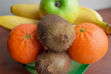 Citrus and fruit (kiwi, apple, tangerine, banana). Close-up