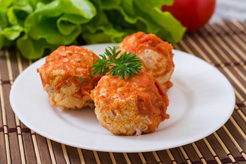 Meatballs in tomato sauce on a white plate