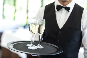 Waiter holding tray of champagne