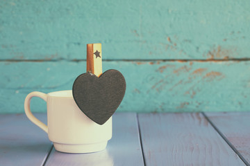 cup of coffee and little heart shape chalkboard
